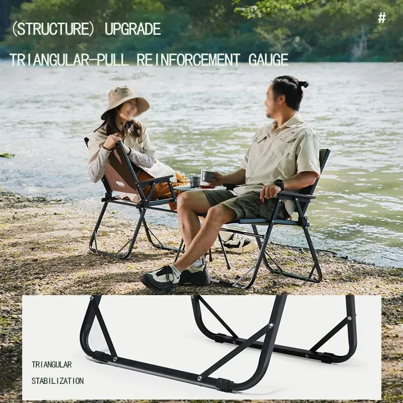 Two people seated in the chairs by a lake, showing the triangular leg reinforcement